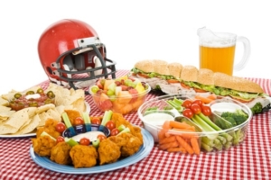 Table set with munchies for a Super Bowl party. White background.