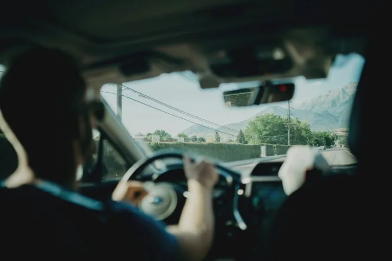 Man driving a car with sunglasses on